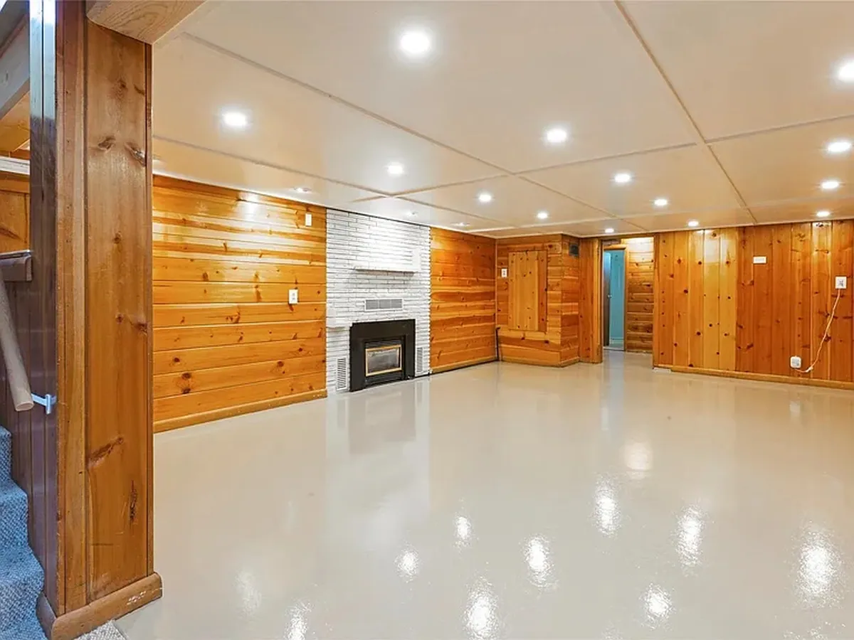 Lower level, wide view after renovation by Saved X Grace Construction