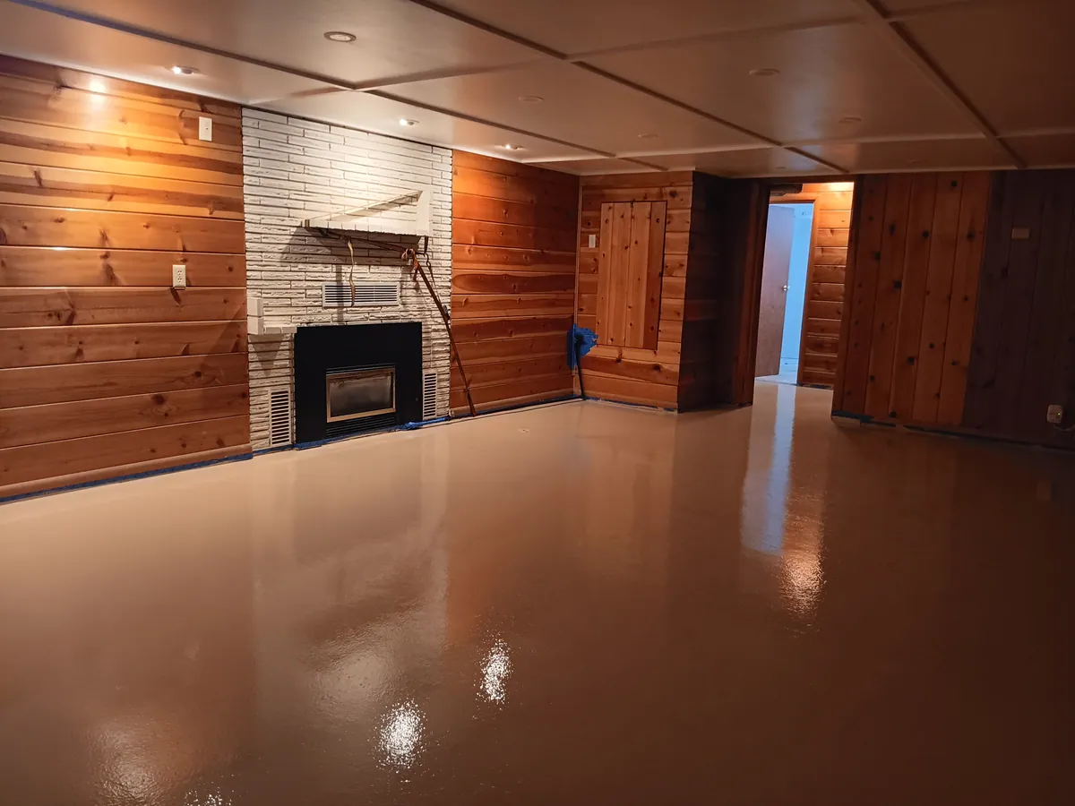 A second view of the epoxy coating spread across the basement slab