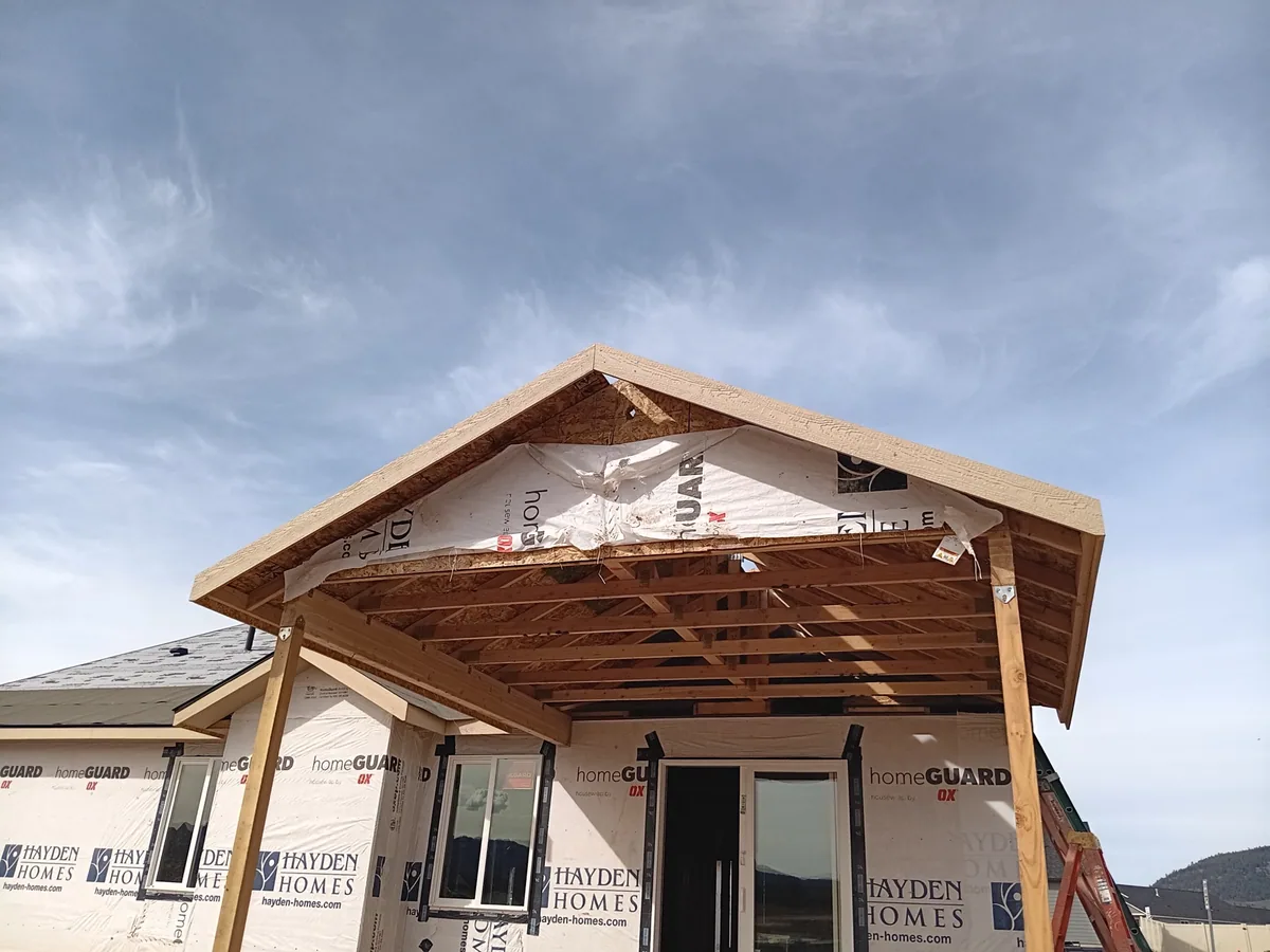 Gable end framing of a covered porch with the roof sheathing partially on