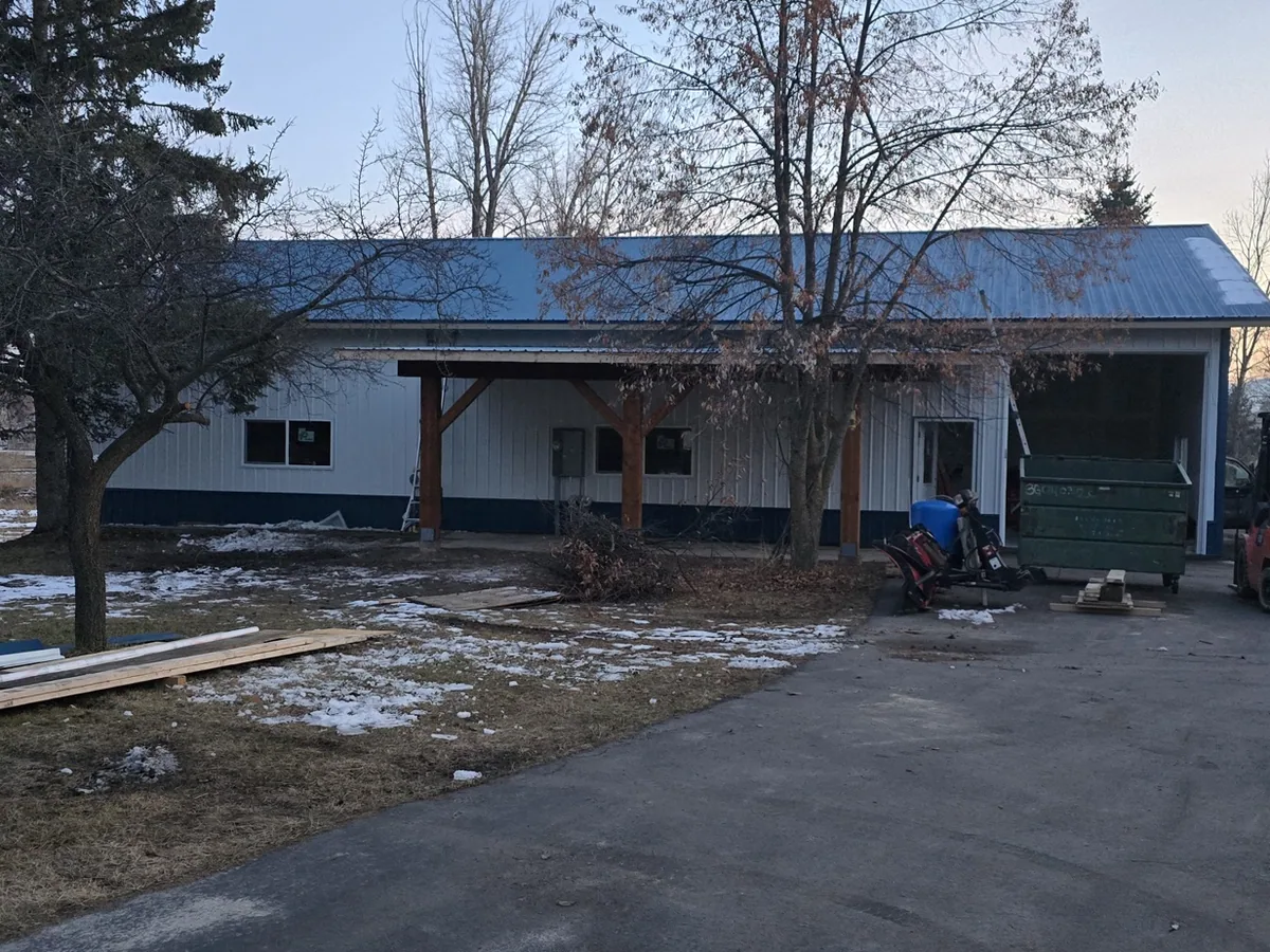 Wide view of the finished covered porch running along the side of the building