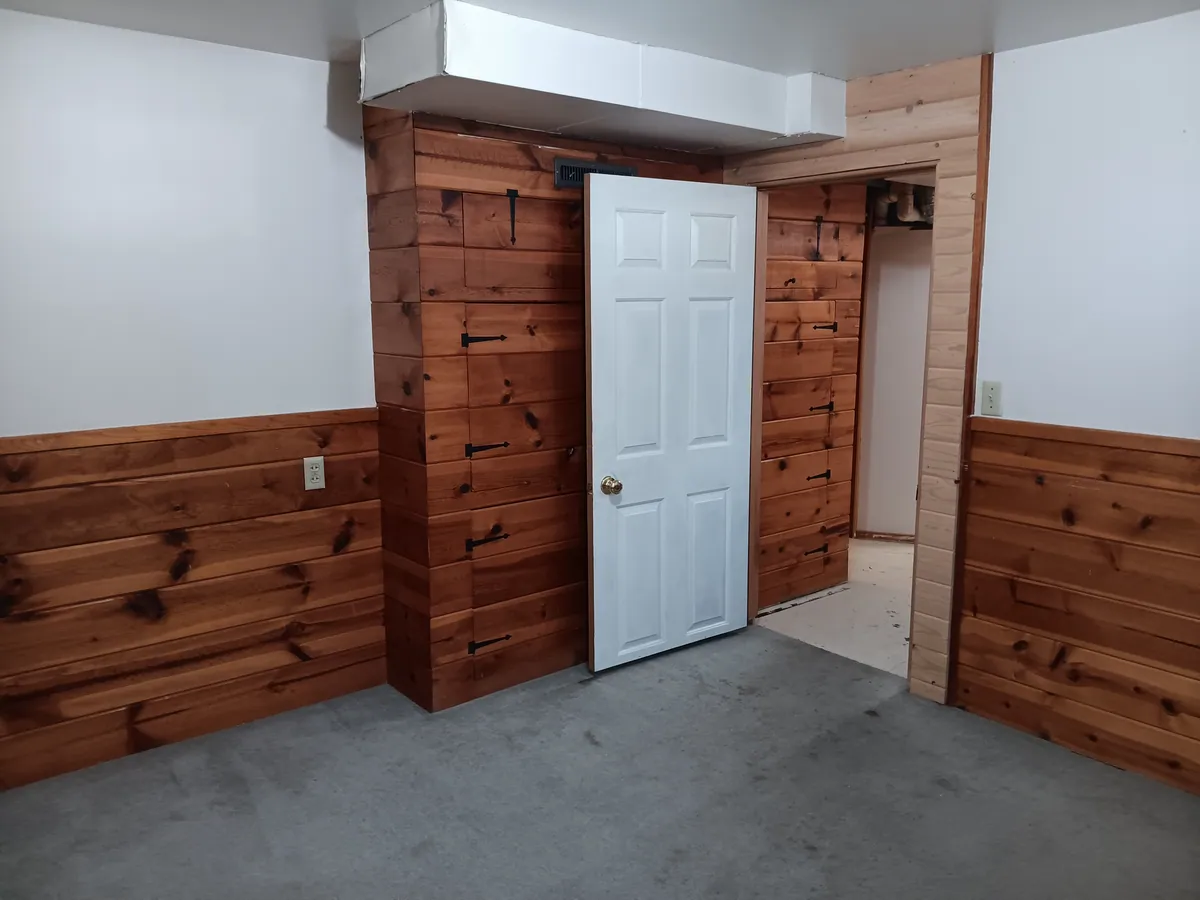 Cedar wainscot and a new six-panel door installed